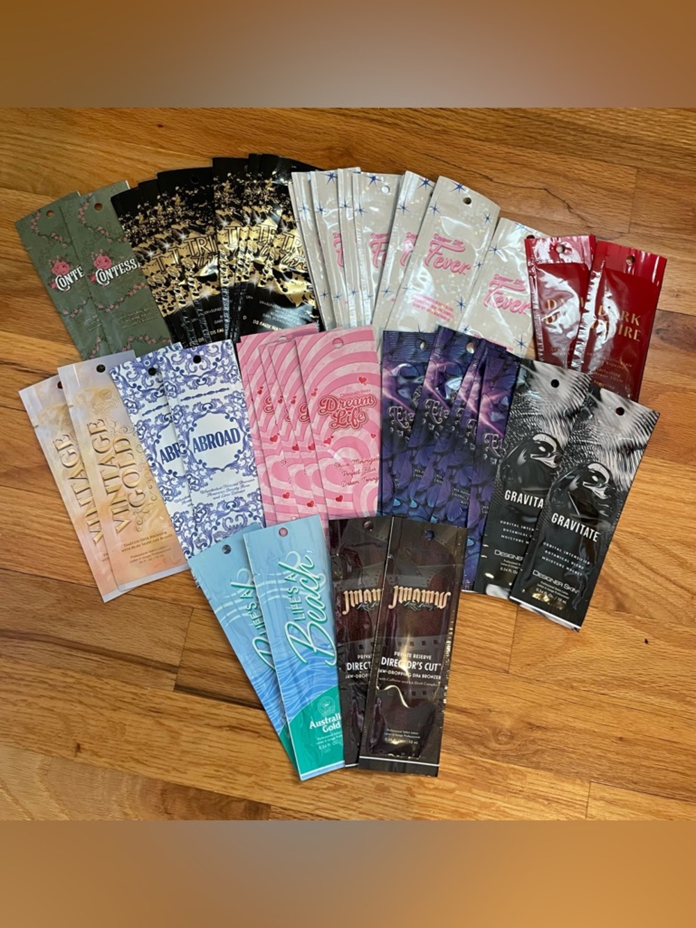 Bundle of tanning lotion sample packets includes fever, triple threat, abroad